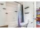 Bathroom with a shower/tub combo, toilet, and built-in shelves for storage at 6110 Raleigh Cir, Castle Rock, CO 80104