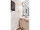 A modern bathroom with a wood vanity and a black faucet, mirror, and drawer pulls at 6110 Raleigh Cir, Castle Rock, CO 80104