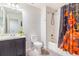 Well-lit bathroom with a vanity, toilet, and a shower featuring an eye-catching shower curtain at 6110 Raleigh Cir, Castle Rock, CO 80104