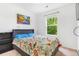 Bright bedroom featuring a comfortable bed, large window with green views, and a decorative painting at 6110 Raleigh Cir, Castle Rock, CO 80104