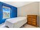 Bedroom featuring a window with blue trim and a dresser with brass pulls at 6110 Raleigh Cir, Castle Rock, CO 80104