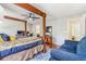 A bedroom with a four-poster bed frame, a ceiling fan, and a small sitting area at 6110 Raleigh Cir, Castle Rock, CO 80104
