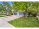 Charming home exterior with a well-manicured lawn, mature trees, and a driveway at 6110 Raleigh Cir, Castle Rock, CO 80104