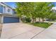 View of the home with large trees, a green lawn, and a spacious driveway at 6110 Raleigh Cir, Castle Rock, CO 80104
