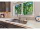 Stainless steel kitchen sink with modern faucet and view of the backyard at 6110 Raleigh Cir, Castle Rock, CO 80104