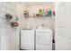 Convenient laundry room equipped with a washer, dryer, and shelving for storage at 6110 Raleigh Cir, Castle Rock, CO 80104