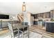 Open-concept living space featuring hardwood floors, a dining table, stainless steel appliances, and stylish decor at 6110 Raleigh Cir, Castle Rock, CO 80104