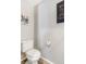 A simple bathroom with a standard toilet and a picture on the wall at 6110 Raleigh Cir, Castle Rock, CO 80104