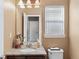 Well-lit bathroom featuring granite counters, a modern sink and faucet, and a window with natural light at 20466 Willowbend Ln, Parker, CO 80138