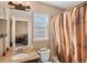 Bright bathroom featuring a granite countertop vanity, bathtub with shower, and window for natural light at 20466 Willowbend Ln, Parker, CO 80138