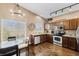 Well-lit kitchen featuring granite countertops, stainless steel appliances, and hardwood floors with breakfast nook at 20466 Willowbend Ln, Parker, CO 80138