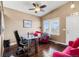 Bright office space with hardwood floors, unique desk, and a comfortable seating area with large window at 20466 Willowbend Ln, Parker, CO 80138