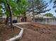 Spacious backyard featuring a patio, large trees, and a wood fence perfect for entertaining at 12599 Elm St, Thornton, CO 80241