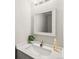Bright bathroom featuring a modern vanity with a white countertop, a stylish mirror, and minimalist decor at 12599 Elm St, Thornton, CO 80241