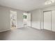 Spacious bedroom with gray walls, carpeted floor, and a closet for ample storage space at 12599 Elm St, Thornton, CO 80241