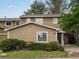 Traditional two-story home with a well-maintained lawn and mature landscaping and a side entrance at 12599 Elm St, Thornton, CO 80241