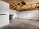 Spacious unfinished garage with a large garage door and utility access, offering plenty of storage at 12599 Elm St, Thornton, CO 80241