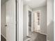 Hallway view showing access to a bathroom and bedroom, highlighting the layout of the home at 12599 Elm St, Thornton, CO 80241