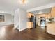 Kitchen featuring light-colored cabinets, stainless steel appliances, granite countertops, and hardwood floors at 12599 Elm St, Thornton, CO 80241
