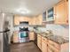 Charming kitchen equipped with stainless steel appliances, light wood cabinets, and tile backsplash at 12599 Elm St, Thornton, CO 80241