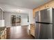 Open kitchen with stainless steel fridge and view of the back patio at 12599 Elm St, Thornton, CO 80241