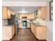 Bright kitchen features stainless steel appliances, light wood cabinets, and beautiful stone countertops at 12599 Elm St, Thornton, CO 80241