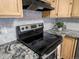 Updated kitchen with stainless steel range and hood with lovely granite countertops at 12599 Elm St, Thornton, CO 80241