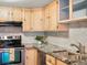 Close up of the kitchen featuring granite counters and stainless appliances at 12599 Elm St, Thornton, CO 80241