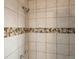 Close-up of the tiled shower showcasing the updated fixtures and design elements at 12599 Elm St, Thornton, CO 80241