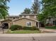 View of home with an attached garage on a manicured lawn at 12599 Elm St, Thornton, CO 80241