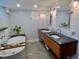Modern bathroom with a soaking tub, double vanity, unique lighting and stylish tile for a luxurious feel at 1315 Grape St, Denver, CO 80220