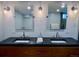 Modern bathroom with dual sinks, decorative mirrors, and updated fixtures at 1315 Grape St, Denver, CO 80220