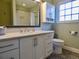 Modern bathroom with a white vanity, patterned floors, updated fixtures and a window for natural light at 1315 Grape St, Denver, CO 80220