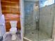 This is a clean bathroom that includes a glass shower, toilet and custom wooden cabinetry at 1315 Grape St, Denver, CO 80220