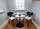 Cozy breakfast nook features a round table with seating for two and a window offering natural light at 1315 Grape St, Denver, CO 80220