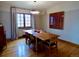 Open concept dining room with wood floors, modern lighting and natural light at 1315 Grape St, Denver, CO 80220