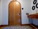 Entryway with a wooden arched door, decorative floor tiles, and side table at 1315 Grape St, Denver, CO 80220