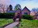 Charming brick home featuring a beautifully landscaped front yard and inviting entryway at 1315 Grape St, Denver, CO 80220