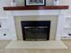 Elegant fireplace with white mantel, white brick surround, and built-in shelving on either side at 1315 Grape St, Denver, CO 80220