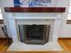 Close-up of a charming fireplace with brick surround and decorative screen at 1315 Grape St, Denver, CO 80220