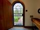 Foyer featuring a unique arched door, decorative floor tiles, and wood accents at 1315 Grape St, Denver, CO 80220