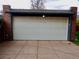 Garage door in a detached brick structure with a dark trim at 1315 Grape St, Denver, CO 80220