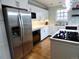 Updated kitchen with stainless steel appliances, white cabinets, quartz countertops and hardwood floors at 1315 Grape St, Denver, CO 80220