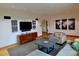 Living room featuring modern console, decor, recessed lights and beautiful hard wood floors at 1315 Grape St, Denver, CO 80220
