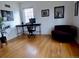 Bright office space with hardwood floors, natural light from a window, a desk and chair, and a cozy couch at 1315 Grape St, Denver, CO 80220