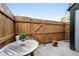Charming back yard with wood fence, patio with small table, and a small chiminea at 1978 Newland Ct, Lakewood, CO 80214