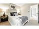 Cozy bedroom featuring a comfortable bed with stylish throw pillows and an ensuite bathroom at 1978 Newland Ct, Lakewood, CO 80214