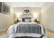 Bright bedroom featuring elegant decor, cozy bedding, soft carpet, and stylish lamps at 1978 Newland Ct, Lakewood, CO 80214
