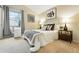 Comfortable bedroom with neutral walls, carpeted floor, bedside tables, and a bright window at 1978 Newland Ct, Lakewood, CO 80214