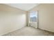 Bright empty bedroom with neutral walls, carpeted floor, and a large window at 1978 Newland Ct, Lakewood, CO 80214